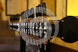 New modern beer taps in pub. Professional bar equipment