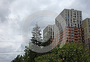 New modern block of flats in green area with blue