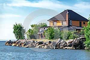 New modern brick house or cottage on the shores of the Kakhovsky reservoir in the Kherson region of Ukraine against the blue sky