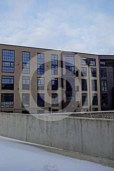 New modern building facade with balconies in Kalamaja district, winter season, snow in the front. Tallinn, estonia