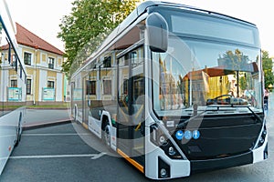 A new modern bus. Modern public electric transport. Details of the bus in close-up, headlights, windshield, driver\'s cabin