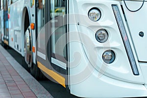 A new modern bus. Modern public electric transport. Details of the bus in close-up, headlights, windshield, driver\'s cabin