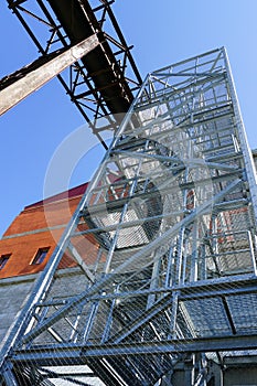 A new modern external steel fire escape stair at the outer wall of factory building