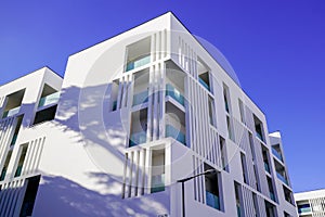 New modern facade white apartment real estate building exterior architecture in blue summer sky