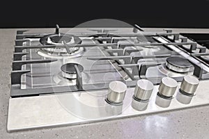 New modern gas stove with four burners for the kitchen, stainless steel surface