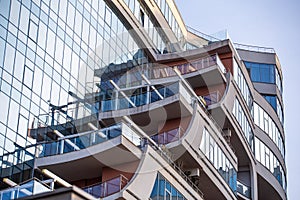 New modern high-rise building with balcony and glass