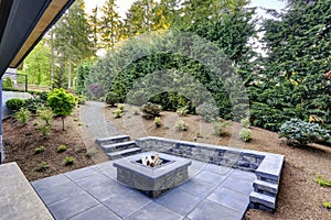 New modern home features a backyard with fire pit