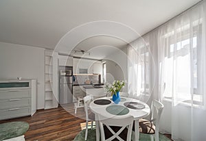 New modern living room with kitchen. New home. Interior photography. Wooden floor.