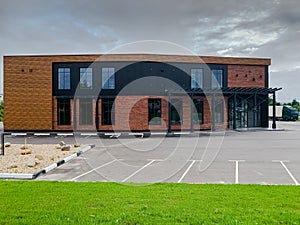 New modern office house with parking lots in front of building. The exterior of two-story modern townhouse