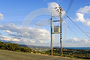 New modern overground wooden low voltage power line pole with electric transformer in rural area