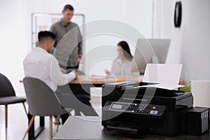 New modern printer on table in office. Space for text
