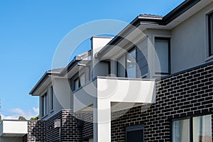 New modern residential townhouse homes. Building of suburban semi-detached townhomes.