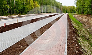 New modern tile sidewalk near a road under construction