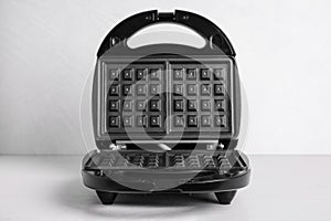 New modern waffle iron on table