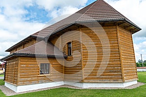 New modern wooden log house. View of a village house against a clear blue sky. roof tiles