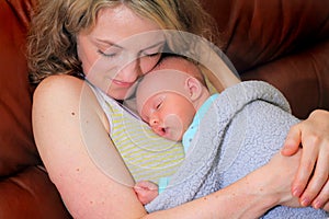 New Mom Cuddles Newborn Baby