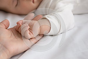 New mom and newborn baby hands close up