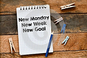 New Monday, new week, new goal text saved in the notebook, top view. Business concept.