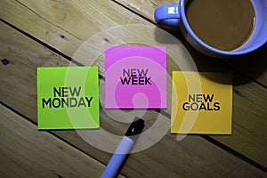 New Monday New Week New Goals text on sticky notes isolated on table background