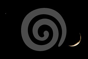 New moon on dark sky