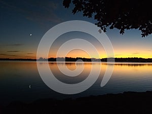 New Moon on the Lake Horizon at Sunset