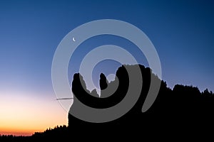 New moon over the mountains ,silhouette of tree and mountains after sunset ,twilight