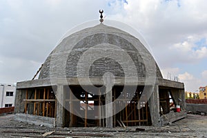 A new mosque under construction, building a new grand Masjid mosque in Cairo, Egypt, with a big dome and high minaret, wooden