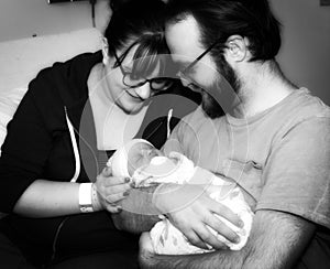 New Mother & Father Hold Their Newborn Daughter at the Hospital