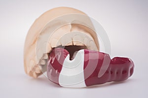 New mouth guard on a light background with latvian flag colors