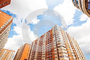 New multi-storey residential building on a blue sky