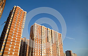 New multi-storey residential building on a blue sky