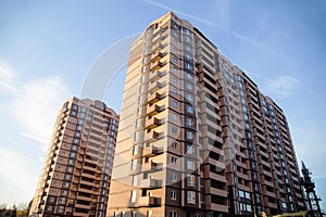 New multi-storey residential building on a blue sky