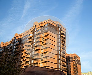 New multi-storey residential building on a blue sky