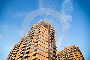 New multi-storey residential building on a blue sky