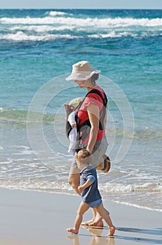 New mum walking on beach