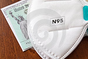 New N95 Medical Face Mask Resting On IRS Covid-19 Economic Relief Check