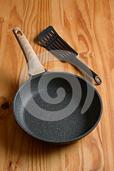 New non-stick frying pan on wooden table