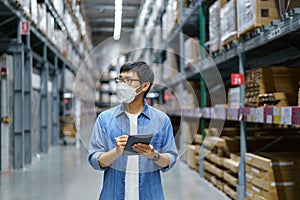 New Normal Asian men, staff, product wearing face mask. counting Warehouse Control Manager Standing, counting and inspecting