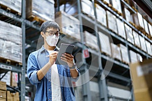 New Normal Asian men, staff, product wearing face mask. counting Warehouse Control Manager Standing, counting and inspecting