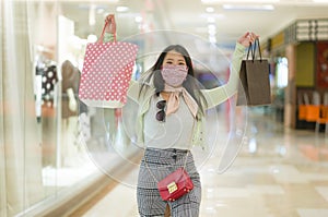 New normal habits - young attractive and happy Asian Korean woman at shopping mall happy and excited enjoying sale in beauty
