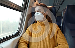 New normal. Passenger in protective mask standing in the train respecting health and safety rules