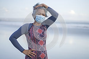 New normal running workout with face mask - attractive and happy middle aged woman on her 40s or 50s ready for post quarantine