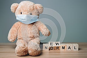 New Normal Teddy bear cute is sitting wearing a mask to protect against a virus that spreads affecting all over the world.