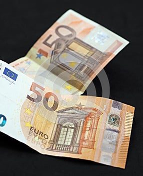 New and old 50 euro banknotes stand on black background
