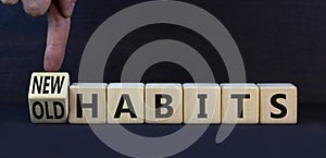 New or old habits symbol. Turned wooden cubes and changed concept words Old habits to New habits. Beautiful grey table grey
