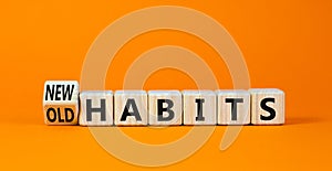 New or old habits symbol. Turned wooden cubes and changed concept words Old habits to New habits. Beautiful orange table orange
