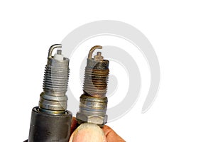 New and old spark plugs on white background