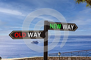 New or old way symbol. Concept word New way Old way on beautiful signpost with two arrows. Beautiful blue sea sky with clouds