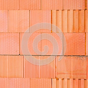 New orange brick wall background. House building worker concept.