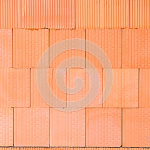 New orange brick wall background. House building worker concept.